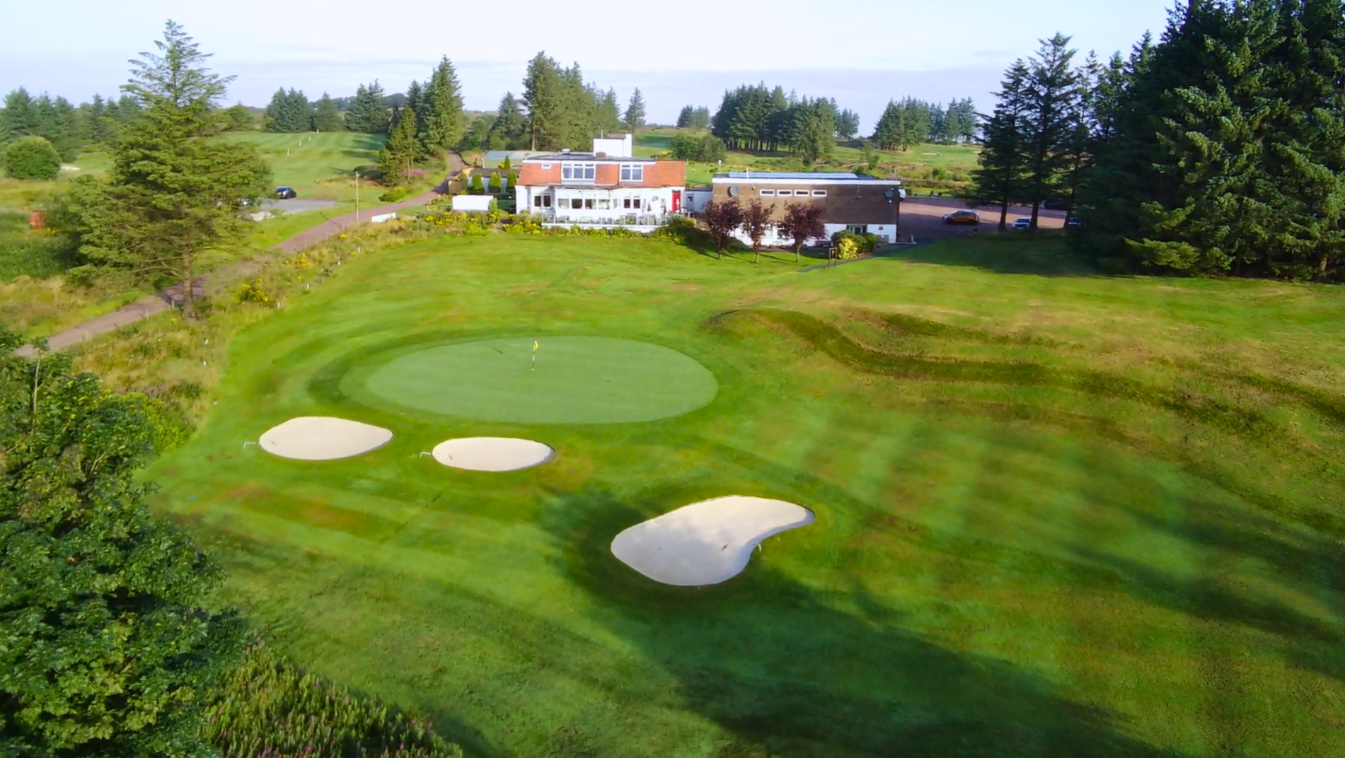Aerial view of the Bonnyton clubhouse above the 18th green and its bunkers