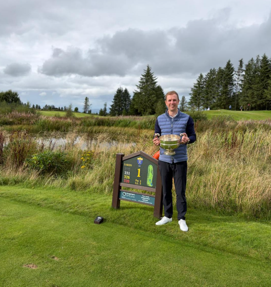 Neil Gray, Bonnyton Golf Club Champion 2026, holding the trophy on the tee